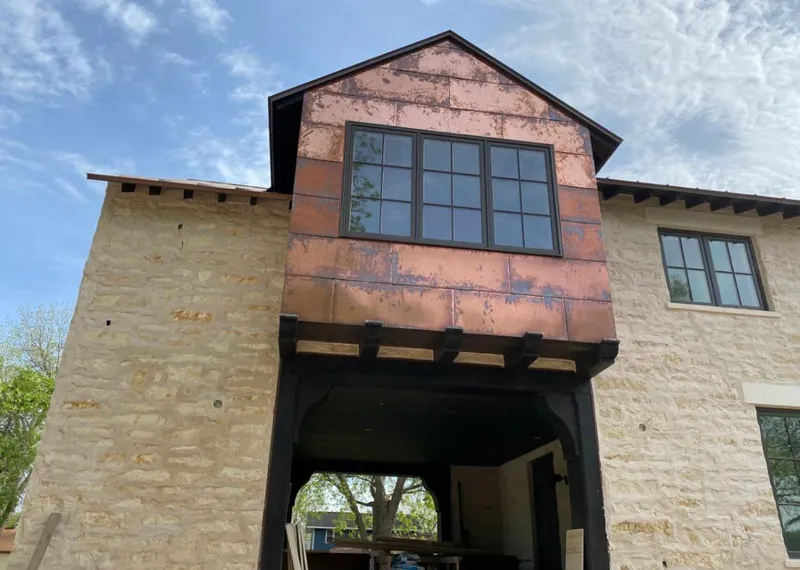 Copper metal panel facade on a stone building for Roof Repair in Alamo Heights
